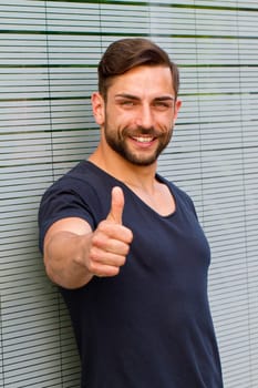 Young man with thumbs up