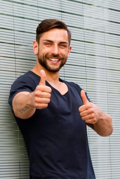 Young man with both thumbs up