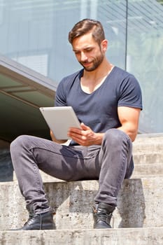 Young man with tablet in the city