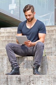 Young man with tablet in the city