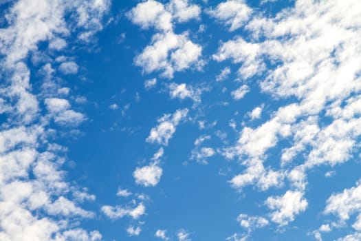 Blue sky with fluffy clouds.