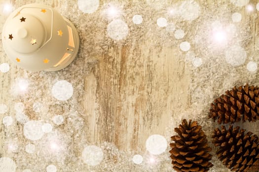 Wooden Christmas background with candle and pine cones..
