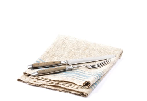 Antique cutlery on linen cloth