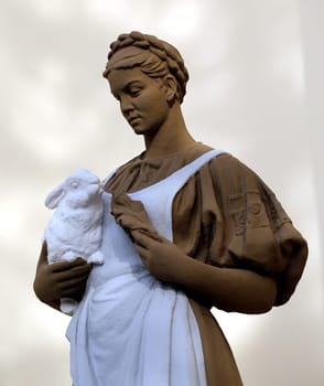 Statue of a girl with a rabbit in the exhibition pavilion building rabbit at ENEA in Moscow