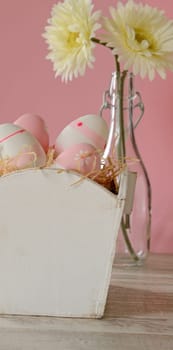 Pink Easter eggs in a wooden box with decoration