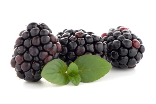 Blackberries with leaves isolated on white background.