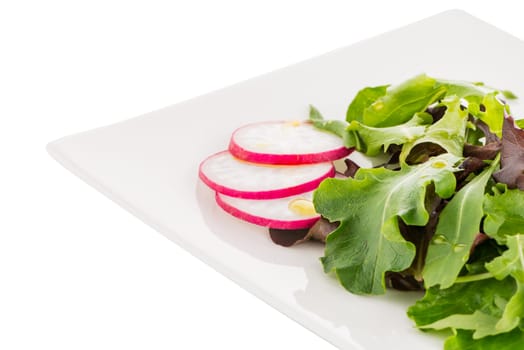 Salad mix with rucola, frisee, radicchio and lamb's lettuce. Isolated on white background.
