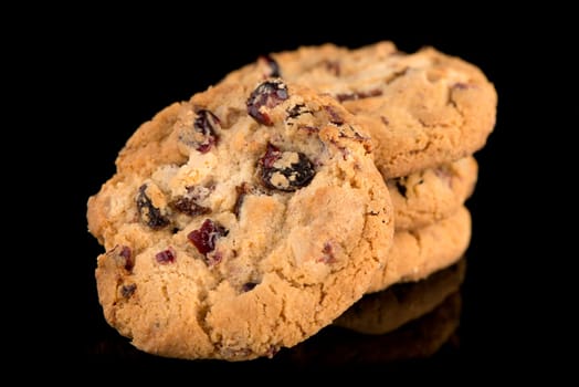 Dried fruits chip cookies isolated on black background.
