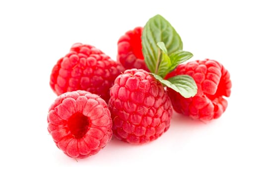 Raspberries with leaves isolated on white background