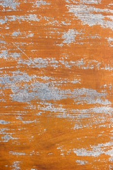 Cracked weathered brown painted wooden board texture.