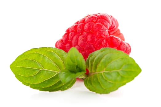 Raspberries with leaves isolated on white background