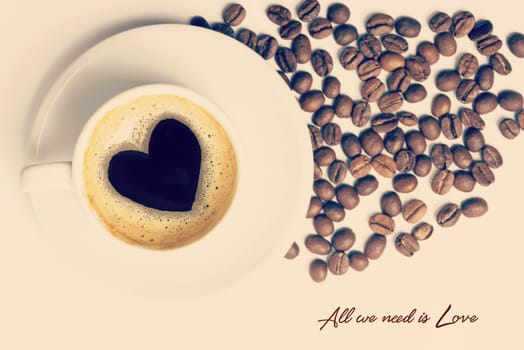 Vintage cup of coffee top view with heart shape made on foam and love quote. Includes clipping path, so you can easily copy and paste it on your own design.