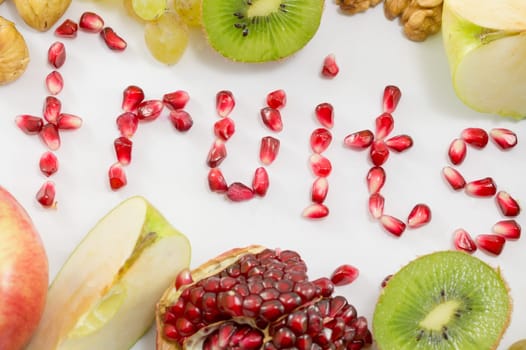 Word fruits written with pomegranate seeds