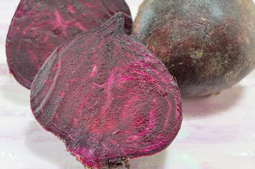 Whole and sliced beetroot on the wooden table