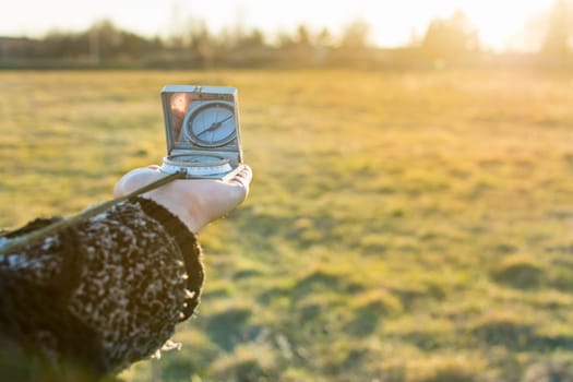 Compass in hand of a girl searching for the right path