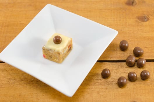 dessert with chocolate ball on top in a white plate