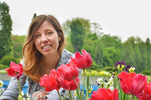 girl with red tulips outdoors