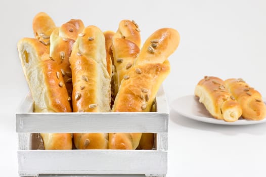 sesame pastry in a white crate isolated