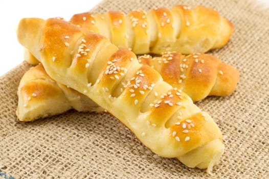 bunch of sesame pastry on a vintage tablecloth