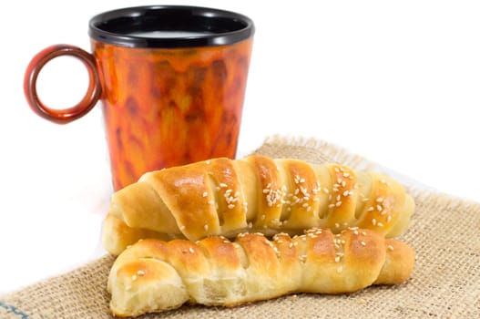 bunch of sesame pastry with a mug of milk