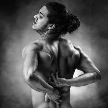 Young athlete who has a painful twinge on steam background