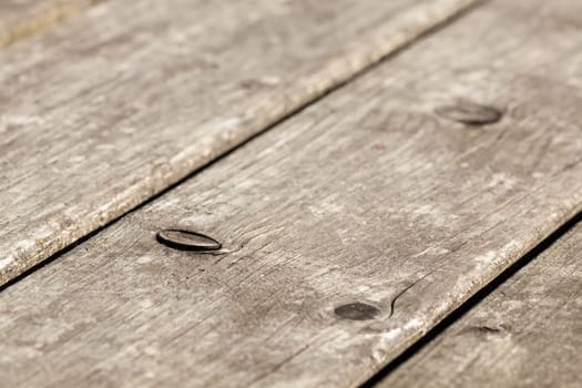 Wood grain with branches - weather-resistant wood surface of a garden table