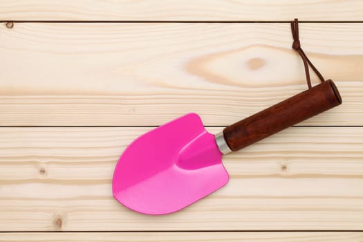 garden shovel on wood background