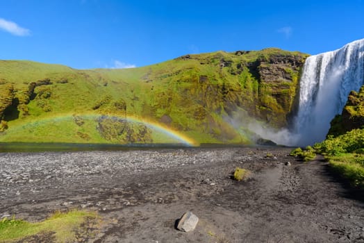 beautiful waterfall Skogafoss with rainbow, famous natural landmark in Iceland