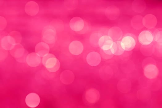 Abstract circular natural light vivid pink bokeh background