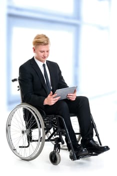 portrait of a young businessman in a wheelchair with tablet computer