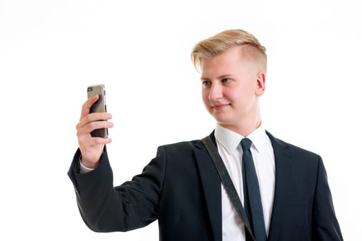 young business man in black suit taking a self-portrait with his phone
