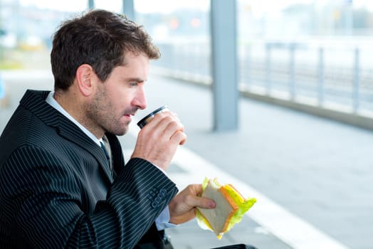 businessman on trip sitting on a bench and has a break
