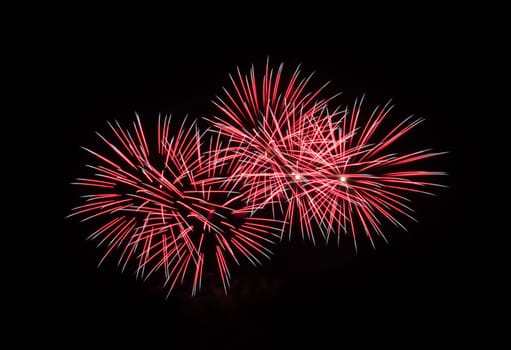 Red fireworks exploding in the night sky