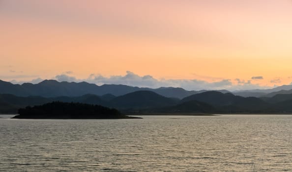 Beautiful nature landscape in sunset light of mountain with lake. Kaeng Krachan Reservoir in Thailand