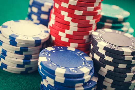 chips for poker on green playing table
