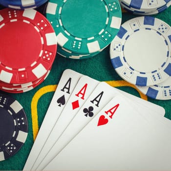 poker four aces on green casino table