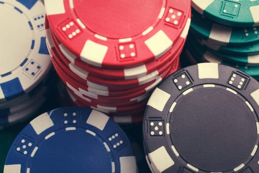 chips for poker on green playing table