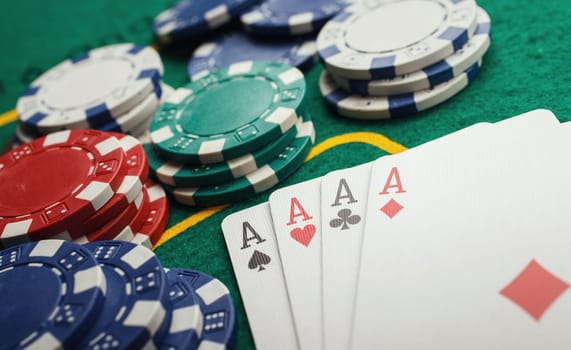 poker four aces on green casino table
