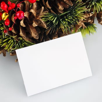green christmas wreath with decorations isolated on white background with blanck card