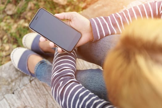 hipster female holding smart phone modern technology