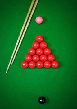 red snooker balls set on a green table, billiards game