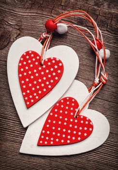 White and red sewed christmas hearts on wooden background, Holiday background for greetings Valentine&#39 s  day