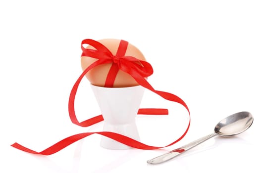 egg with  red festive ribbon isolated on white