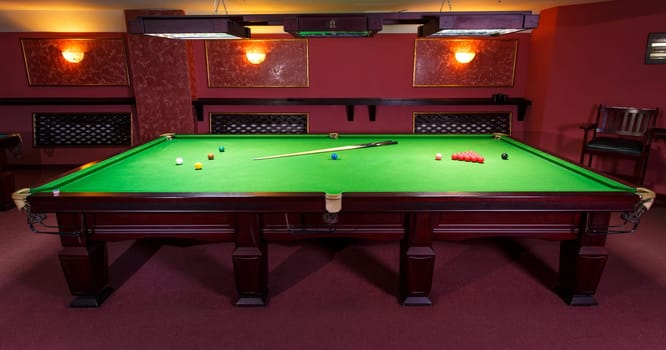 A Pool Table, set up for a game,  front view