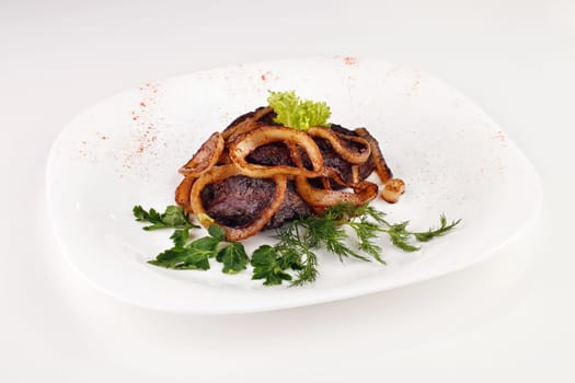 barbecue with onions and cabbage, parsley in a bowl isolated
