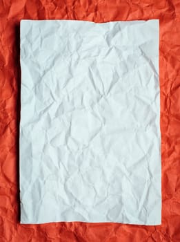 Crumpled  white paper card on red background, place for tex
