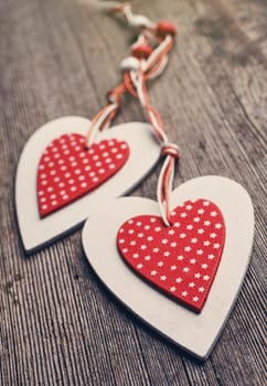 White and red sewed christmas hearts on wooden background, Holiday background for greetings Valentine's  day