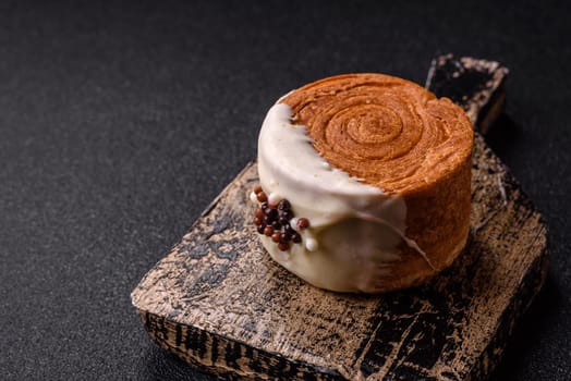 Round sweet New York roll croissant with pistachio cream filling on a dark concrete background