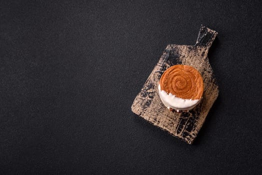 Round sweet New York roll croissant with pistachio cream filling on a dark concrete background