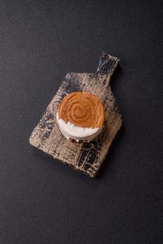 Round sweet New York roll croissant with pistachio cream filling on a dark concrete background